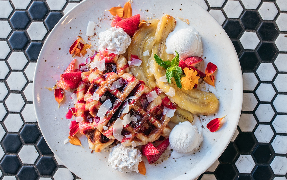 a plate of waffles with banana